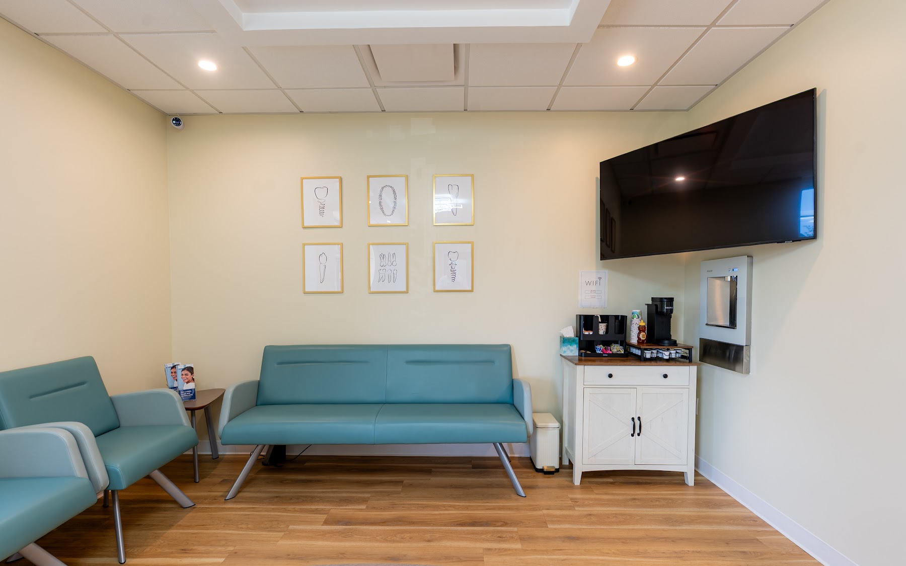 Bright waiting room with soft teal seating at Brilliant Dental of Salem